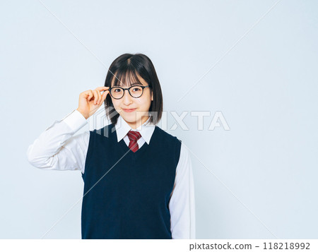 A female student wearing a uniform and glasses 118218992