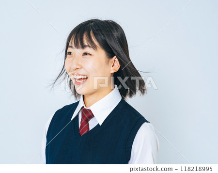 A female student in uniform with her hair blowing in the wind 118218995