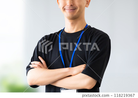 Smiling male businessman with arms crossed Smiling male businessman with arms crossed 118219367