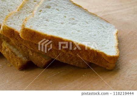Fresh slices of bread displayed on wooden table. Healthy food concept Fresh slices of bread displayed on wooden table. Healthy food concept 118219444
