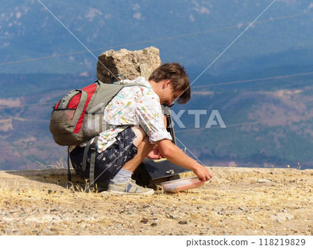 Summer's Endurance: Hiker's Trial on Sardinia's Arid Peak 118219829