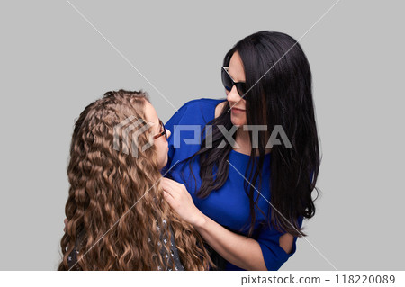 Mother and daughter bonding moment with smiles and stylish sunglasses Mother and daughter bonding moment with smiles and stylish sunglasses 118220089