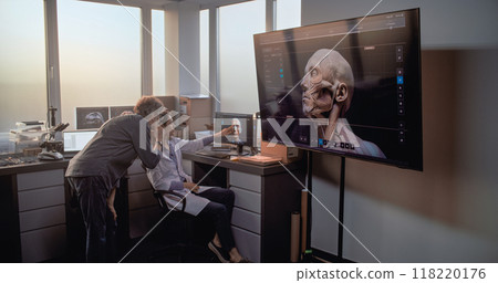 Male and female archaeologists use PC and big screen with displayed 3D model of ancient human 118220176