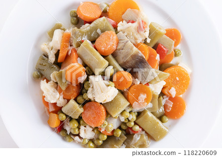 vegetable stew (menestra de verduras) on a plate isolated on white background. Top view. Copy space 118220609