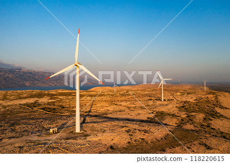 PAG ISLAND, CROATIA - JULY 14 2024: Wind turbines placed on Pag Island for alternative energy production. Modern technology to transform wind into sustainable source of power in Croatia PAG ISLAND, CROATIA - JULY 14 2024: Wind turbines placed on Pag Island for alternative energy production. Modern technology to transform wind into sustainable source of power in Croatia 118220615