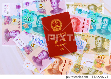 Passport issued by People Republic of China is accompanied by cash yuan money banknote of various denominations Passport issued by People Republic of China is accompanied by cash yuan money banknote of various denominations 118220771