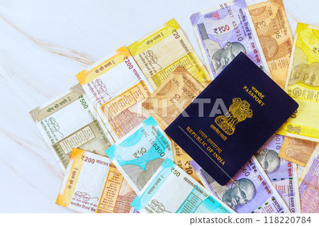 Passport Republic of India containing Indian rupees of various denominations 118220784
