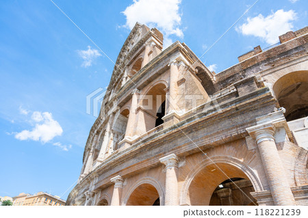 Tourists explore the Colosseum in Rome, Italy, marveling at its grandeur and historical significance on a sunny day 118221239