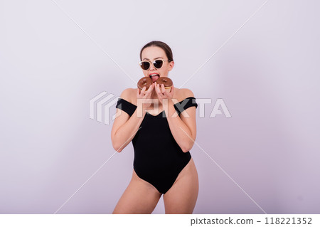 Plus size seductive model female, fashionable blonde in black bodysuit with donut 118221352