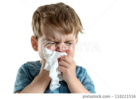 A crying little boy with a crumpled tissue in his hand, against a white background. 118221516