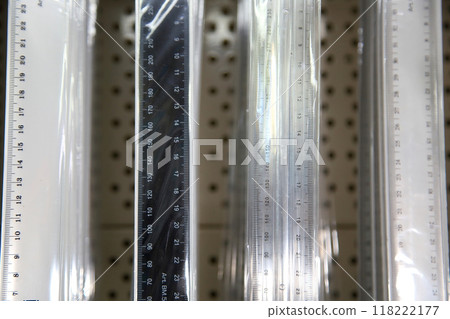 School rulers made of wood and plastic. School supplies, stationery accessories. School rulers in packaging in the store. Goods for office and study. 118222177