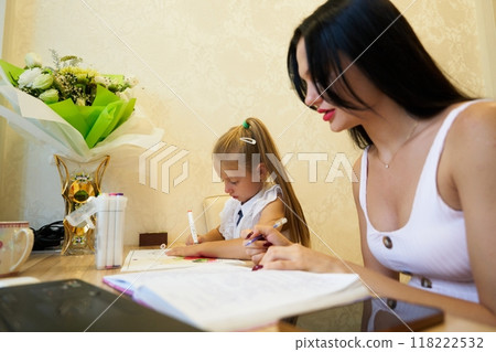 Mother and daughter enjoying creative time at home in a cozy environment 118222532