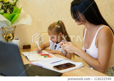 Mother and daughter engage in creative coloring activity at home Mother and daughter engage in creative coloring activity at home 118222540
