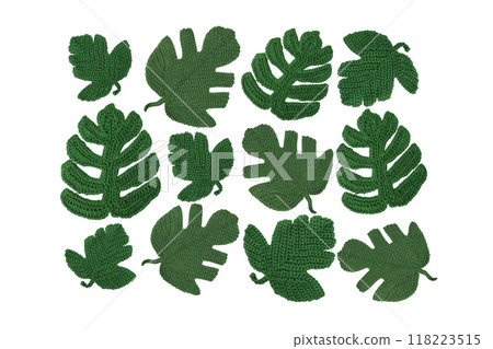 Abstract background of knitted green leaves of monstera isolated on white background. Leaf pattern. Hobbies of knitting toys and home decorations. Banner, flat lay, copy space. 118223515
