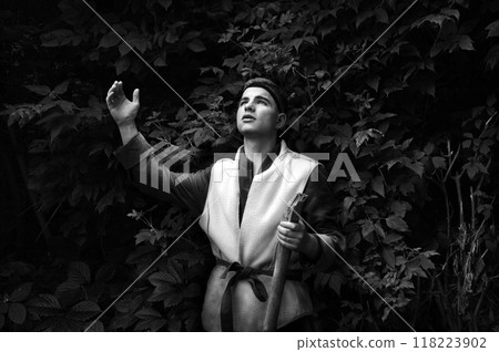 Praying man with raised hand 118223902