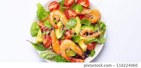 Healthy salad with grilled shrimps, avocado, cherry tomatoes and green leaves on white plate isolated on white background top view. Clean eating, nutrition and dieting concept 118224060