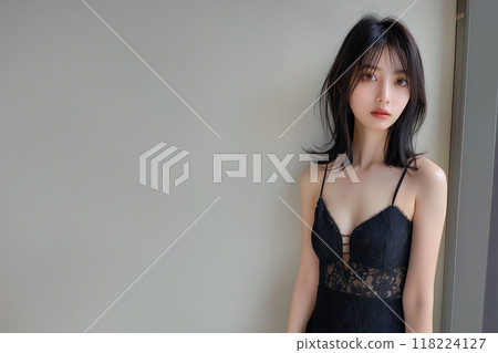 A beautiful woman in a simple and mature black dress 118224127