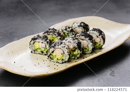 Sushi rolls with shrimp, avocado, and black caviar, perfect for Japanese cuisine and food styling 118224571