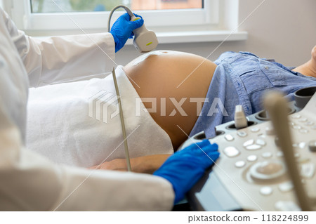 Pregnant woman on third trimester having ultrasonography in clinic Pregnant woman on third trimester having ultrasonography in clinic 118224899