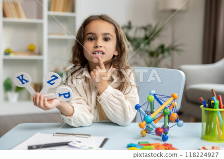 Cute long-haired girl of school girl in the office of a speech therapist 118224927