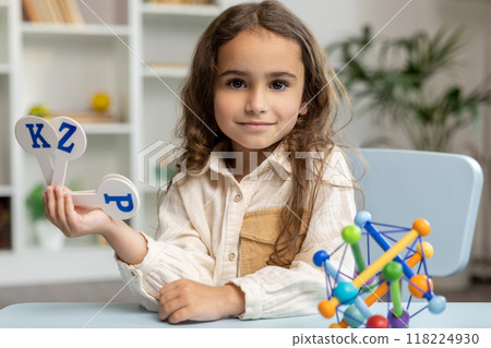 Cute long-haired girl of school girl in the office of a speech therapist 118224930