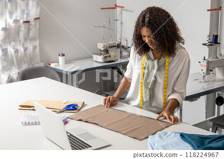 Hard working woman working on fashionable couture handling beautiful fabrics 118224967