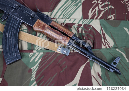 AK assault rifle on camo uniform background AK assault rifle on camo uniform background 118225084