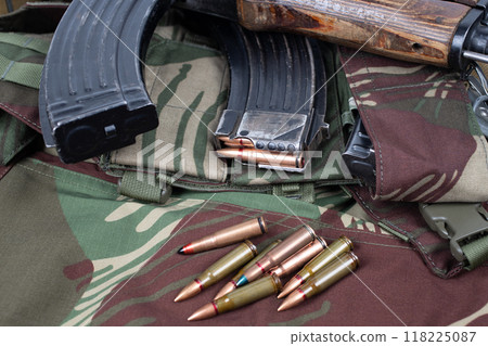 AK assault rifle on camo uniform background 118225087