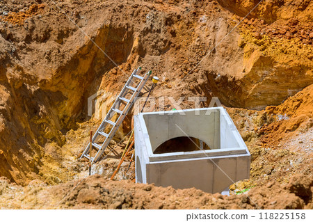 Installation of drainage concrete collectors manhole,well sewer system inside for rain water underground at construction site. Installation of drainage concrete collectors manhole,well sewer system inside for rain water underground at construction site. 118225158