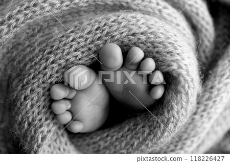 Foot of a newborn. Close up feet, toes, heels, feet of a newborn baby. Studio monochrome, vintage style, black and white macro photography. 118226427