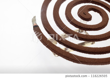 A mosquito coil with smoke coming out of it 118226505