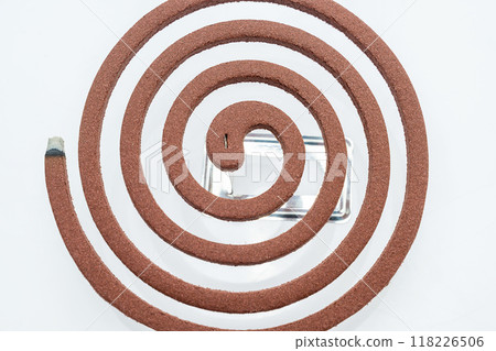 A mosquito coil with smoke coming out of it 118226506