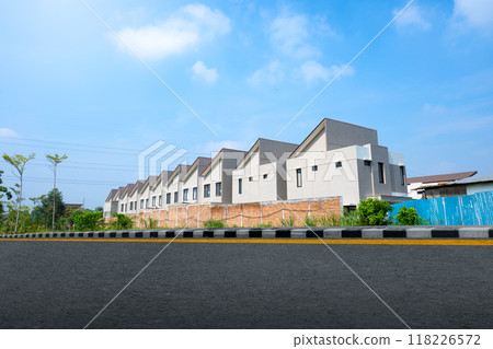 A row of houses with a green tree in the background 118226572