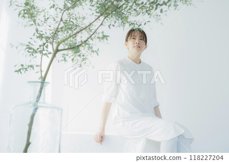 Middle-aged woman in a white dress Middle-aged woman in a white dress 118227204