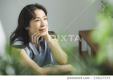 Middle-aged woman by the window Middle-aged woman by the window 118227255