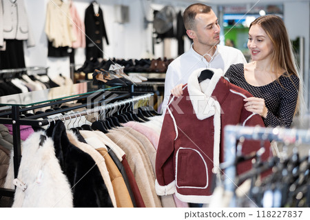 Couple man and woman choosing fur coat 118227837