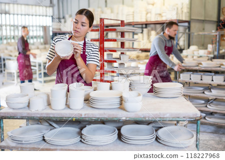 Young woman posing with ceramic blanks Young woman posing with ceramic blanks 118227968