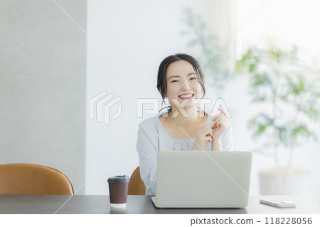 Young woman working remotely Young woman working remotely 118228056