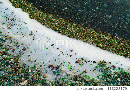Multi-colored glass on the ice and snow of Japanese sea. Glass beach, Russia Multi-colored glass on the ice and snow of Japanese sea. Glass beach, Russia 118228179