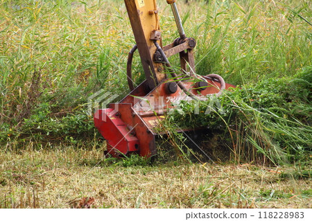 Image of a weeding operation using a grass cutting attachment attached to an excavator Image of a weeding operation using a grass cutting attachment attached to an excavator 118228983