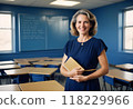 A professional female teacher standing in the classroom holding a book Generated by AI 118229966