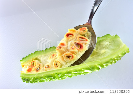 Summer vegetable bitter melon, fully ripe, red seeds and spoon, cotton Summer vegetable bitter melon, fully ripe, red seeds and spoon, cotton 118230295