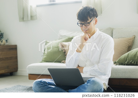 一個人在客廳裡使用個人電腦 118231026