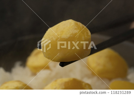 Chestnut rice: Lifting chestnut rice from a bowl with chopsticks 118231289