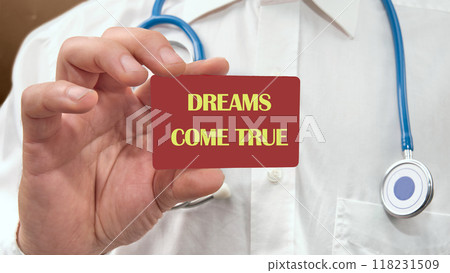 Conceptual dreams come true symbol. Copy space. Dreams come true words on the red card in the man's hand 118231509