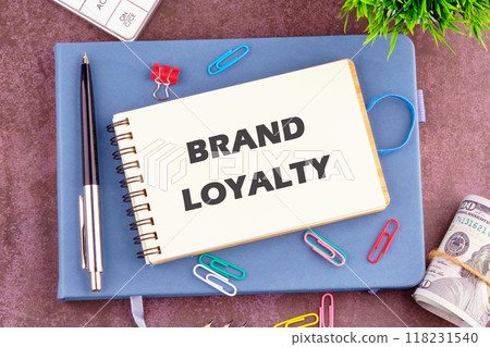 Conceptual brand loyalty symbol. Copy space. BRAND LOYALTY in a notebook in a composition with office supplies, top view Conceptual brand loyalty symbol. Copy space. BRAND LOYALTY in a notebook in a composition with office supplies, top view 118231540