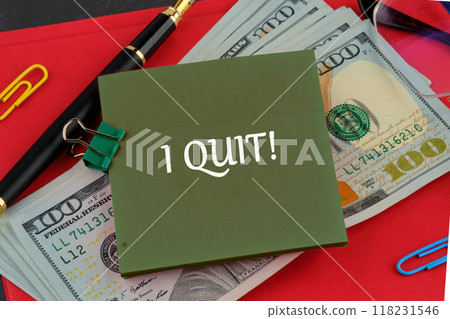 Life and business motivational inspirational concept. I QUIT on a green sticker on the background of dollar bills on the red book 118231546