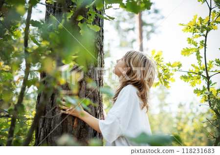 Teenager girl hugging tree. 118231683