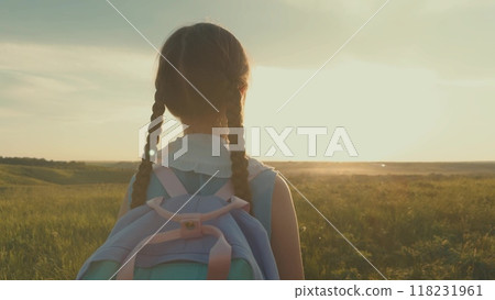 small child backpack, girl daughter sunset, view from back, child looking sunset, first grader praying before first lesson, lesson school, kid child girl looking sunset cinematic, children dream 118231961
