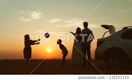 Family at sunset by car in field silhouettes. Children kids plays ball parents hugging enjoying romantic atmosphere happy moment. Importance of Spending Time Together Creating Lasting Family Memories Family at sunset by car in field silhouettes. Children kids plays ball parents hugging enjoying romantic atmosphere happy moment. Importance of Spending Time Together Creating Lasting Family Memories 118232110